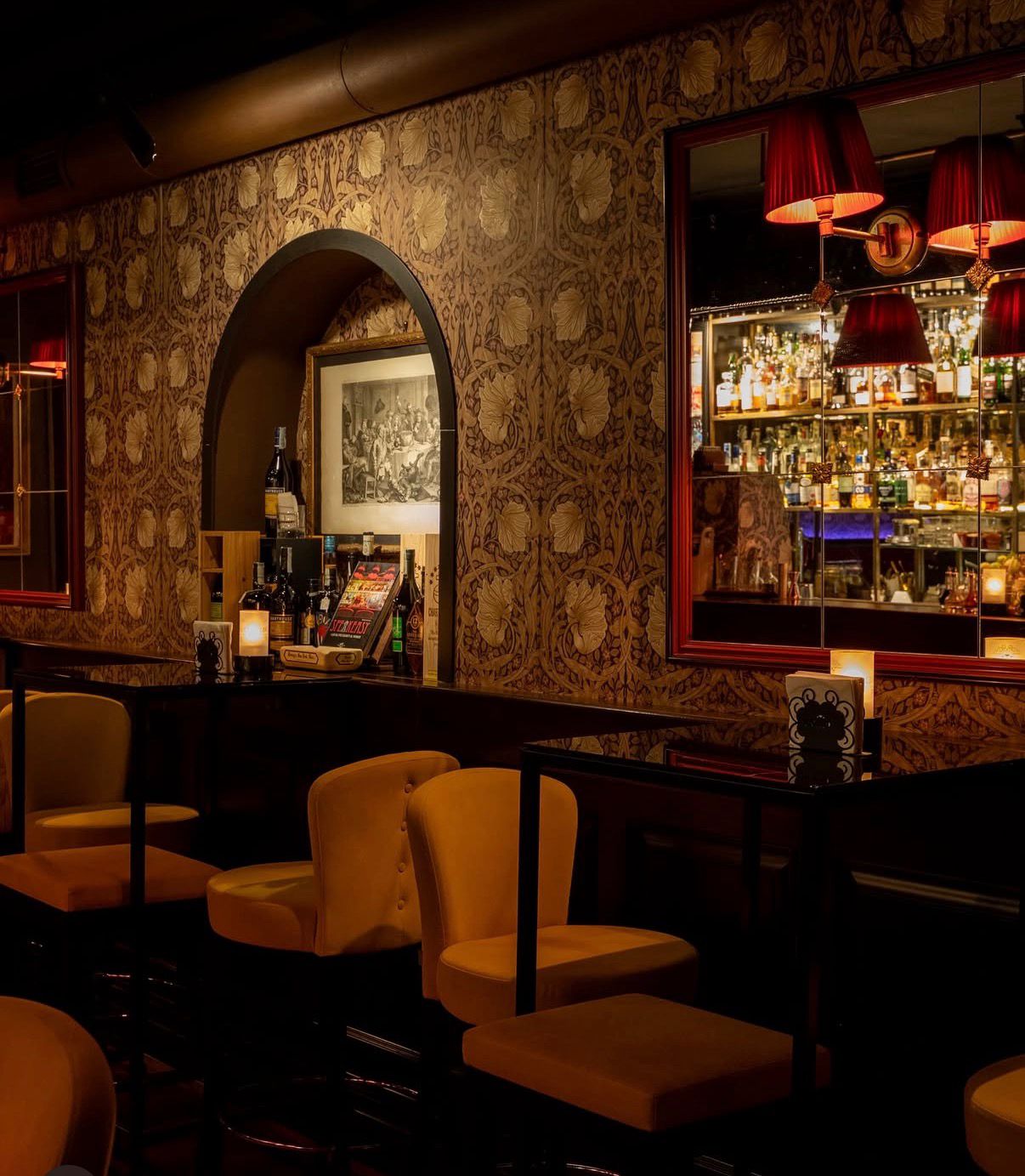 Farmacia Bar Interieur — warmes Licht, ornamentale Tapete, Bar im Hintergrund